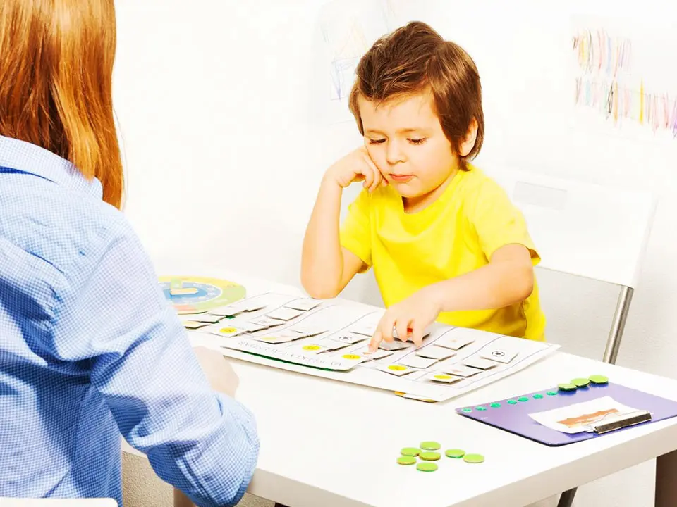 A little boy solving the puzzle