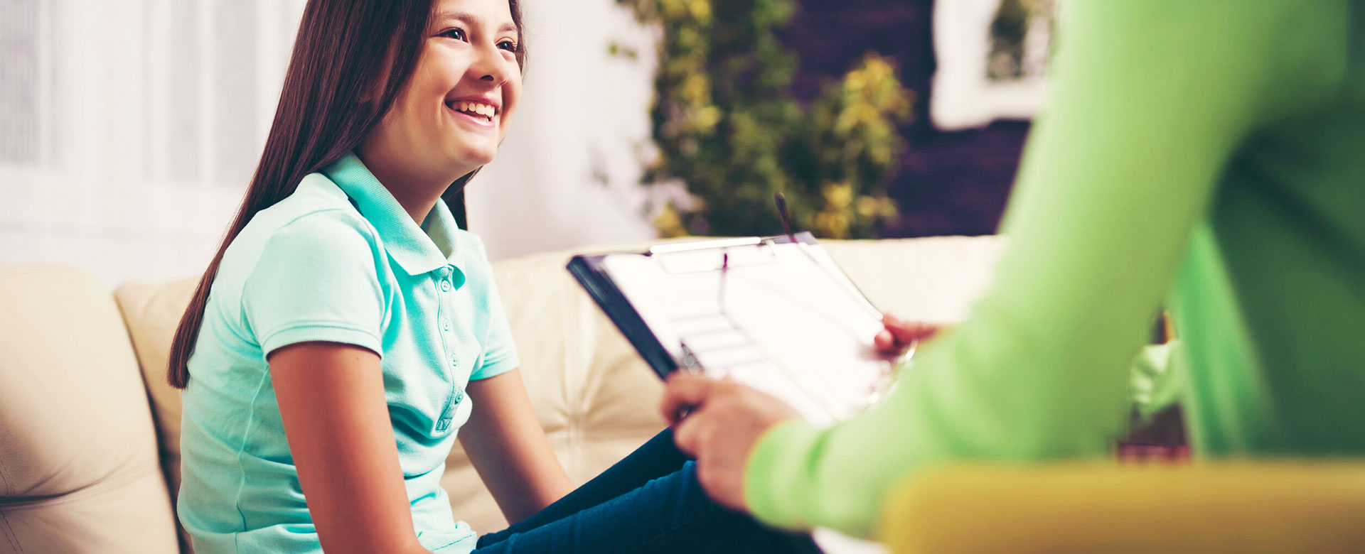 A girl is laughing white talking to therapist